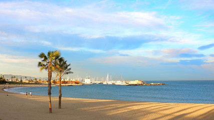 Barcelona landscape, view on Port Olimpic, Mediterranean sea, Barceloneta beach and mountains in the horizon.