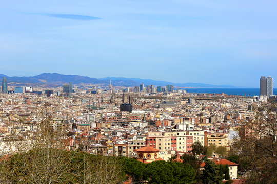 Panoramic view from National Art Museum of Catalonia on Barcelona with skyscrapers and the sea