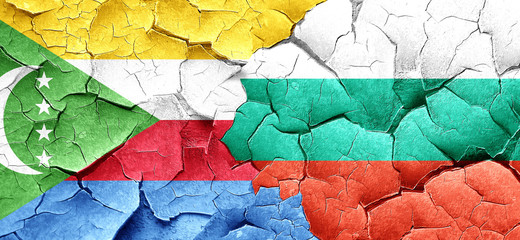 Comoros flag with Bulgaria flag on a grunge cracked wall