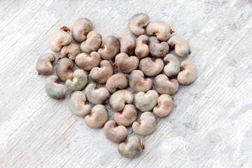Heart shape collection of raw cashew nuts in shell