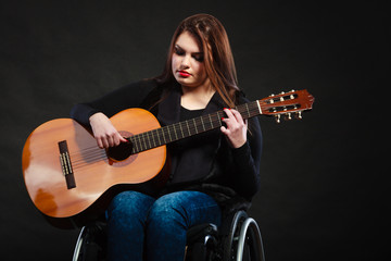 Fototapeta na wymiar Disabled girl playing guitar.