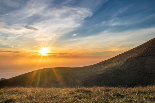 Sunset over California ocean, runner on hill at Mount Tamalpais
