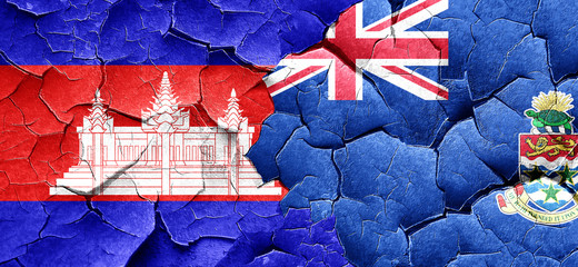 Cambodia flag with Cayman islands flag on a grunge cracked wall