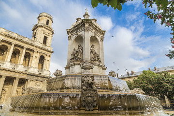 Fototapeta na wymiar Fountain in front of the church of Saint-Sulpice