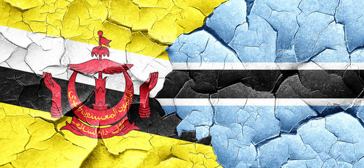 Brunei flag with Botswana flag on a grunge cracked wall