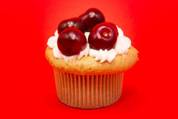 Isolated cupcake with cherries