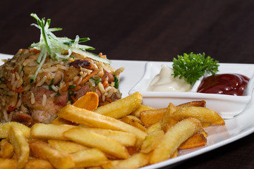 chicken fried rice with fries and a salad