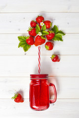 Strawberry smoothie in mason jar with straw