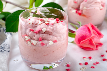 Strawberry dessert in glasses and pink rose, decorated with sugar hearts. Valentines Day background