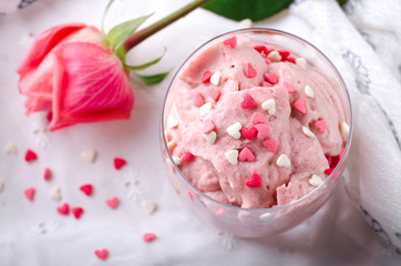 Strawberry dessert in glasses and pink rose, decorated with sugar hearts. Valentines Day background