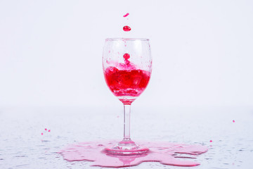 Red wine splash on white background.