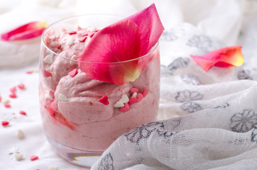 Strawberry dessert in glasses and pink rose, decorated with sugar hearts. Valentines Day background
