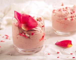 Strawberry dessert in glasses and pink rose, decorated with sugar hearts. Valentines Day background