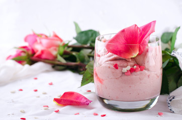 Strawberry dessert in glasses and pink rose, decorated with sugar hearts. Valentines Day background