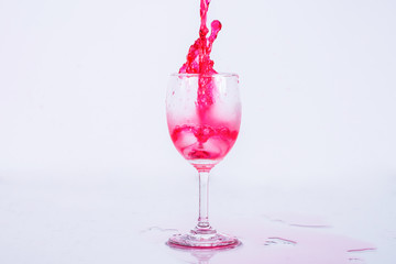 Red wine splash on white background.