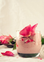 Strawberry dessert in glasses and pink rose, decorated with sugar hearts. Valentines Day background