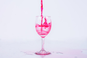 Red wine splash on white background.
