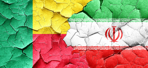 Benin flag with Iran flag on a grunge cracked wall