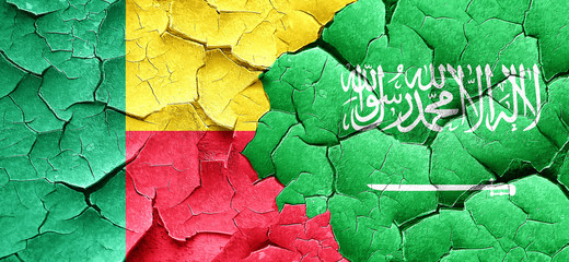 Benin flag with Saudi Arabia flag on a grunge cracked wall