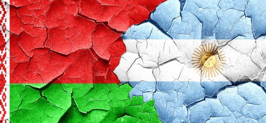 Belarus flag with Argentine flag on a grunge cracked wall