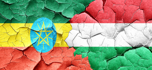 Ethiopia flag with Hungary flag on a grunge cracked wall