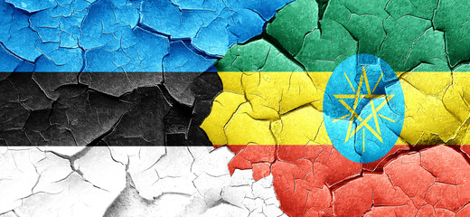 estonia flag with Ethiopia flag on a grunge cracked wall