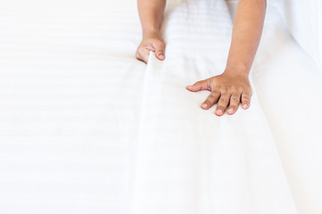 Hand set up white bed sheet in hotel room