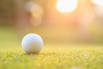 Golf ball on green grass in course