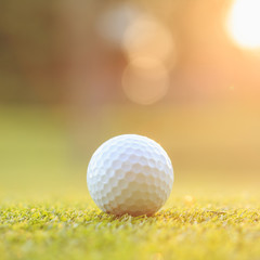 Golf ball on green grass in course