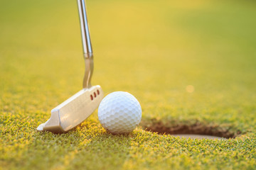 Golf ball on lip of cup  in course