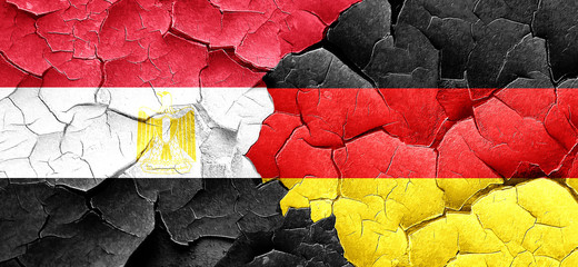Egypt flag with Germany flag on a grunge cracked wall