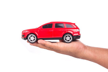 Hand holding red model car isolated on white
