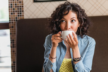 Closeup portrait of a gorgeous young female smelling cof