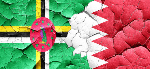 Dominica flag with Bahrain flag on a grunge cracked wall