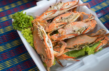 Soft focus steamed crabs in a foam box