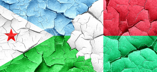 Djibouti flag with Madagascar flag on a grunge cracked wall