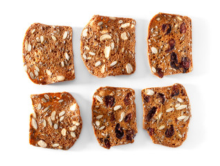 multigrain bread slices with fruits and nuts close-up on white background
