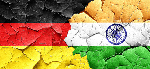 German flag with India flag on a grunge cracked wall