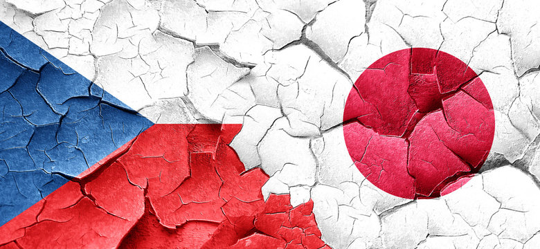 czechoslovakia flag with Japan flag on a grunge cracked wall