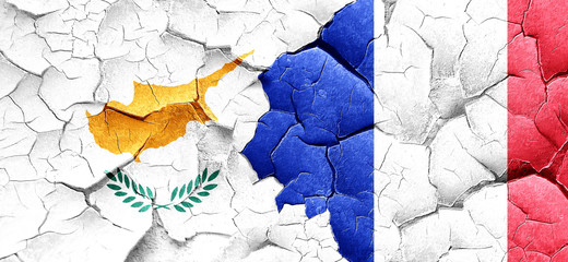 Cyprus flag with France flag on a grunge cracked wall