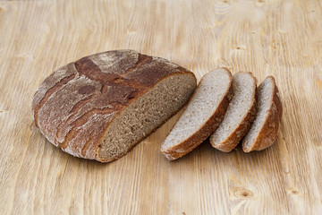 Fresh sliced rye bread on a wooden table