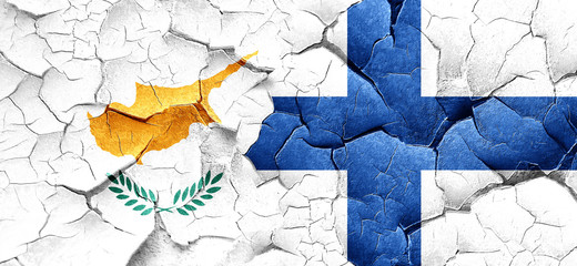 Cyprus flag with Finland flag on a grunge cracked wall
