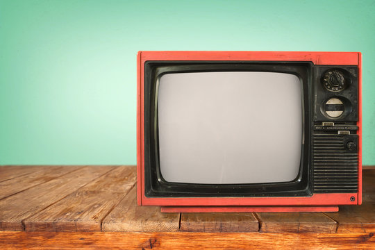 Retro television - old TV on wood table, vintage technology