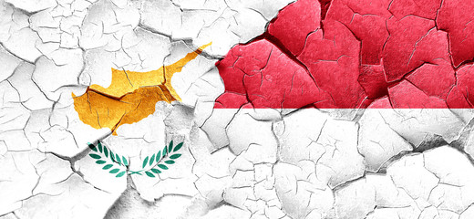 Cyprus flag with Indonesia flag on a grunge cracked wall
