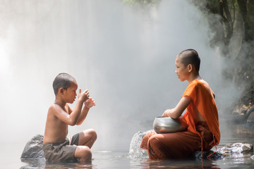 Monk and boy playing water