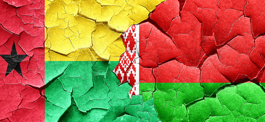 Guinea bissau flag with Belarus flag on a grunge cracked wall
