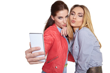 Two women friends taking selfie with smartphone.