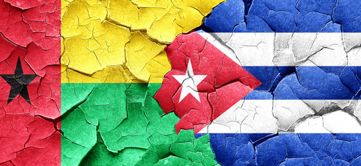 Guinea bissau flag with cuba flag on a grunge cracked wall