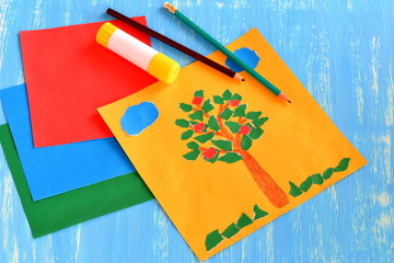 Torn paper summer collage. Clouds, sun, apple tree made out of torn paper. Collage crafts for babies, kids, preschoolers. Idea for development of fine motor skills. Colored paper set, pencils, glue