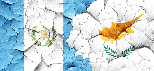 guatemala flag with Cyprus flag on a grunge cracked wall